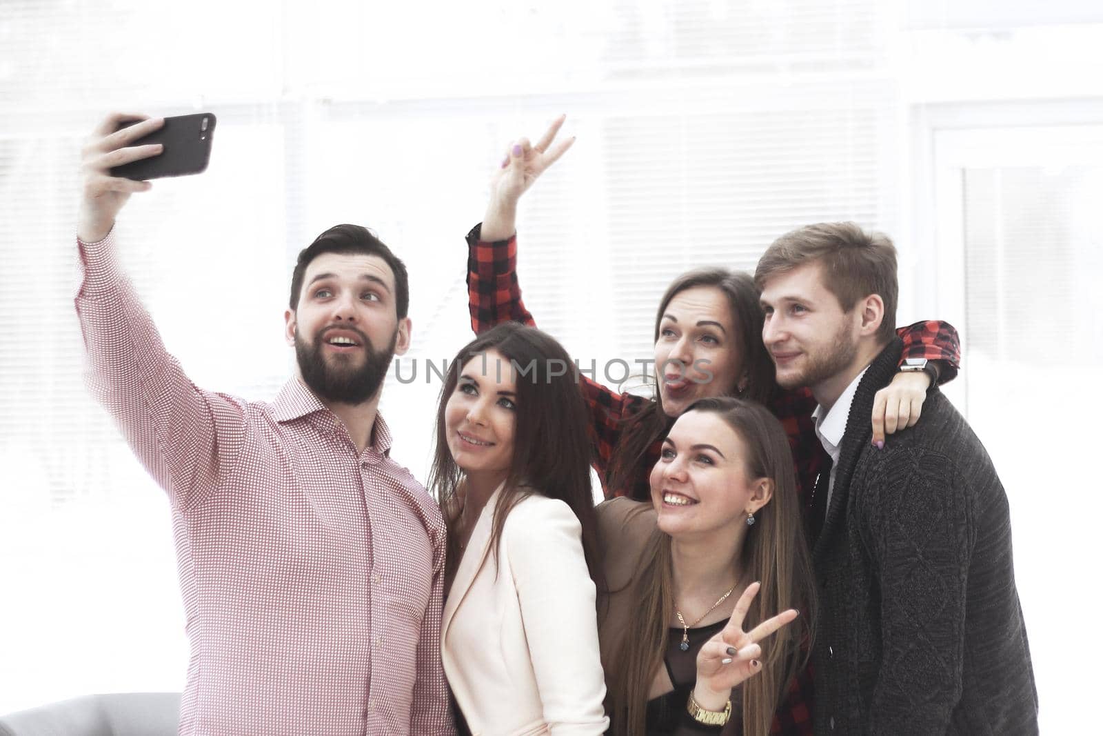 creative business group takes selfies in a modern office by SmartPhotoLab