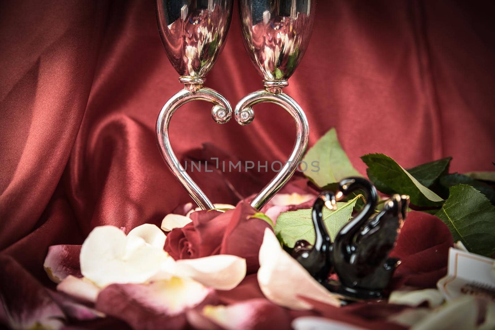 wedding wine glasses and a pair of black swans on a festive background. photo with copy space