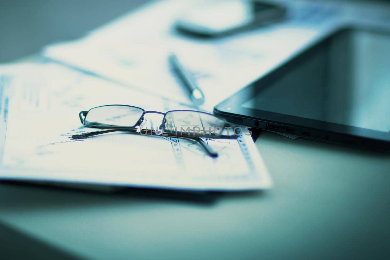 Business financial analysis of the workplace with the glasses on the documents in office
