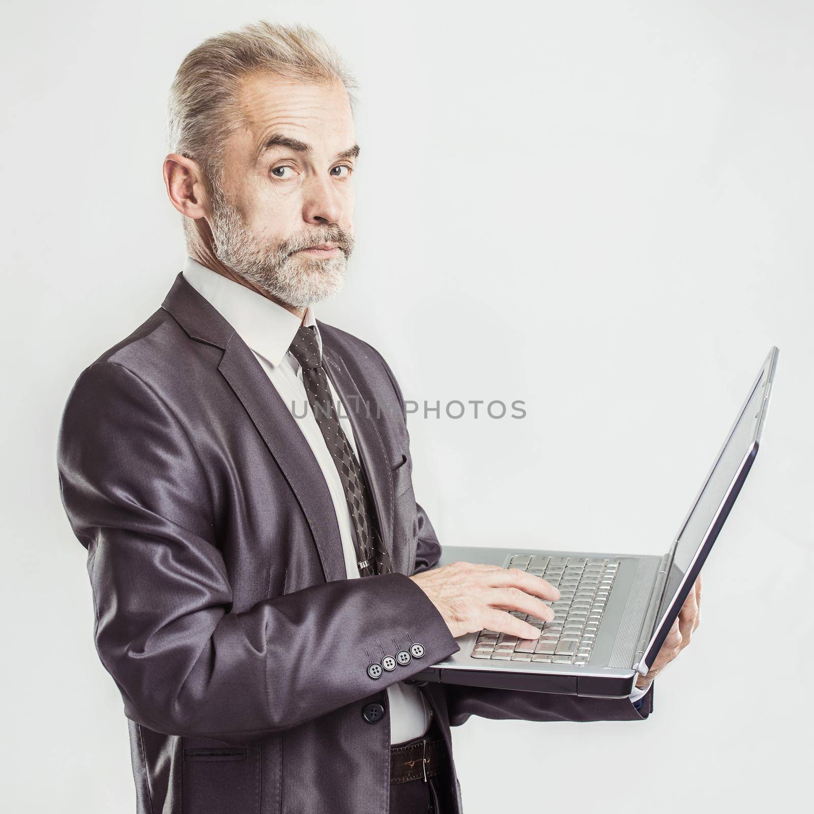 businessman with an open laptop on a white background. the photo has a empty space for your text