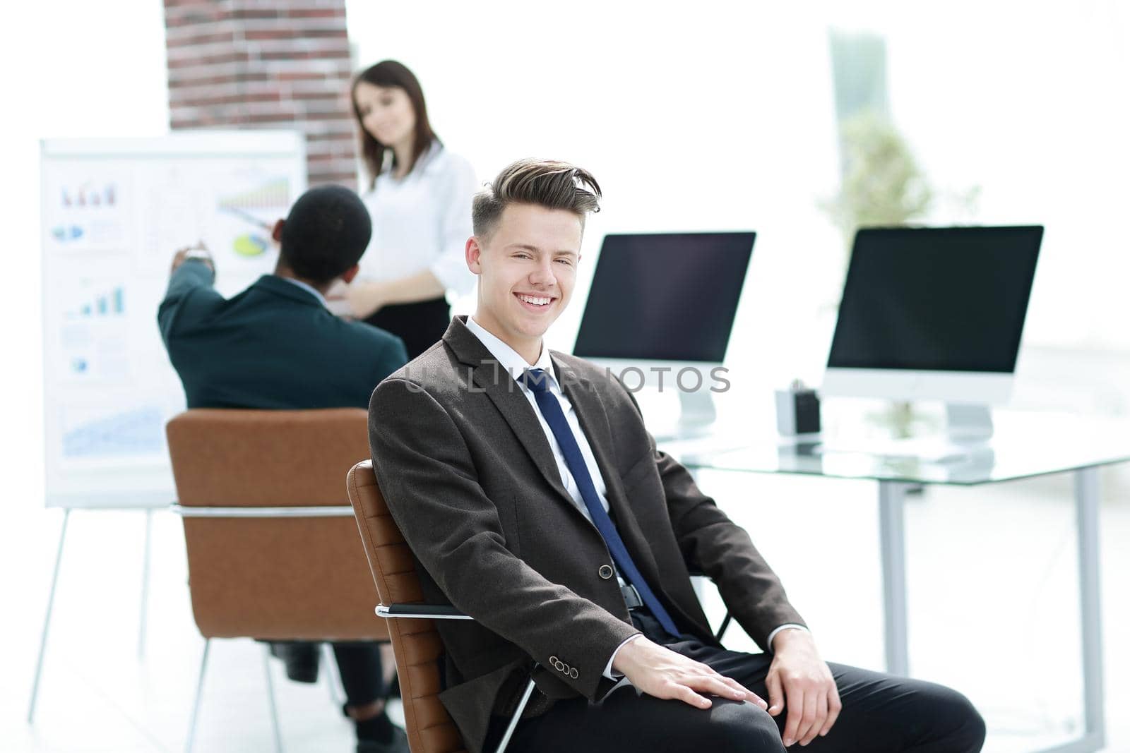 portrait of young employees sitting near the desktop in the office.