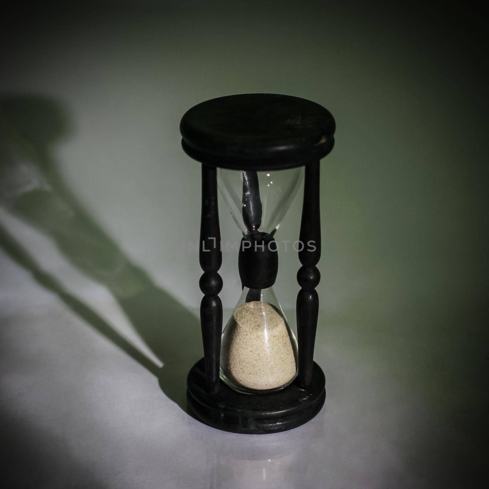 hourglass on dark background.the concept of time.photo with copy space