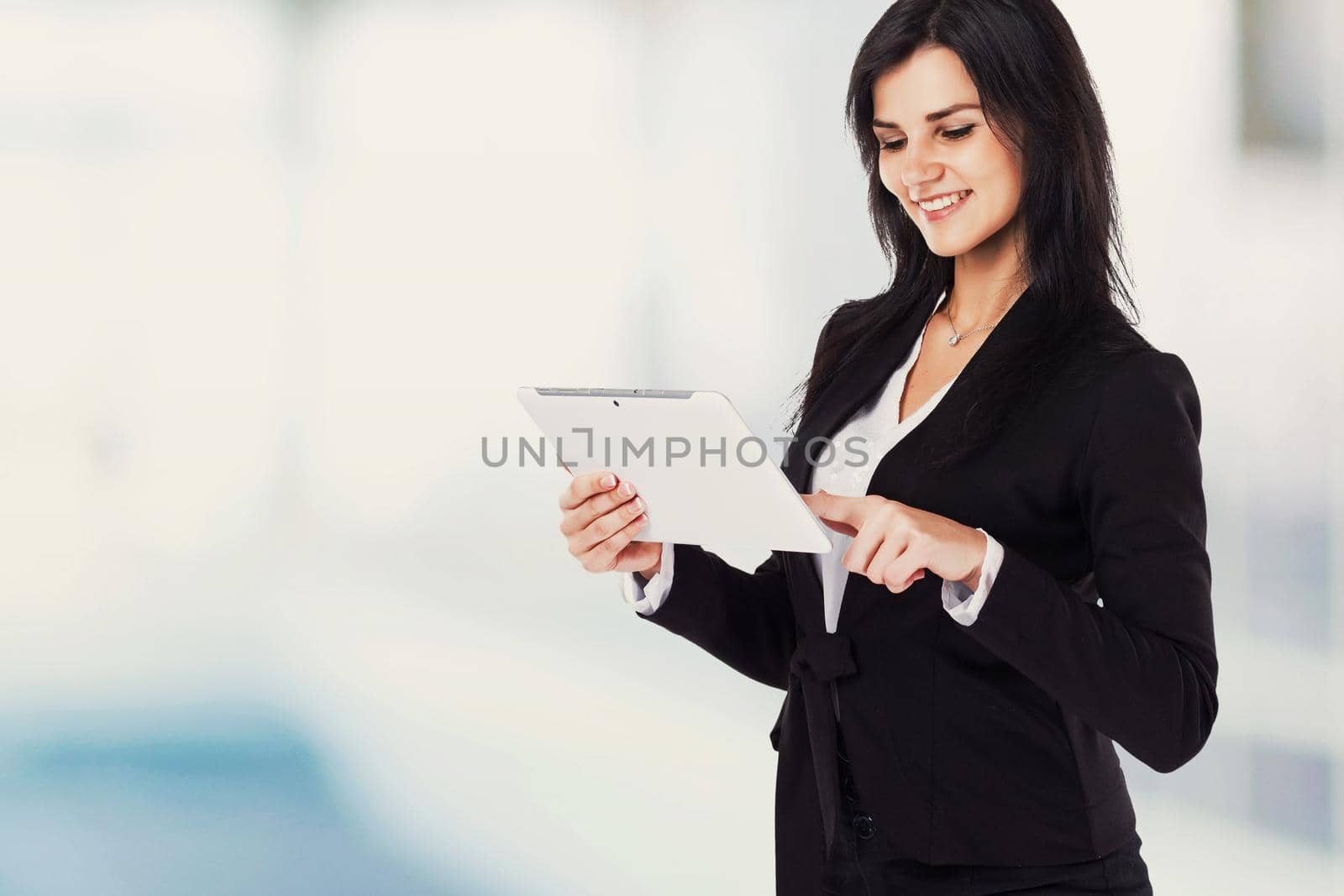 young, successful business woman working with documents on a light background. by SmartPhotoLab