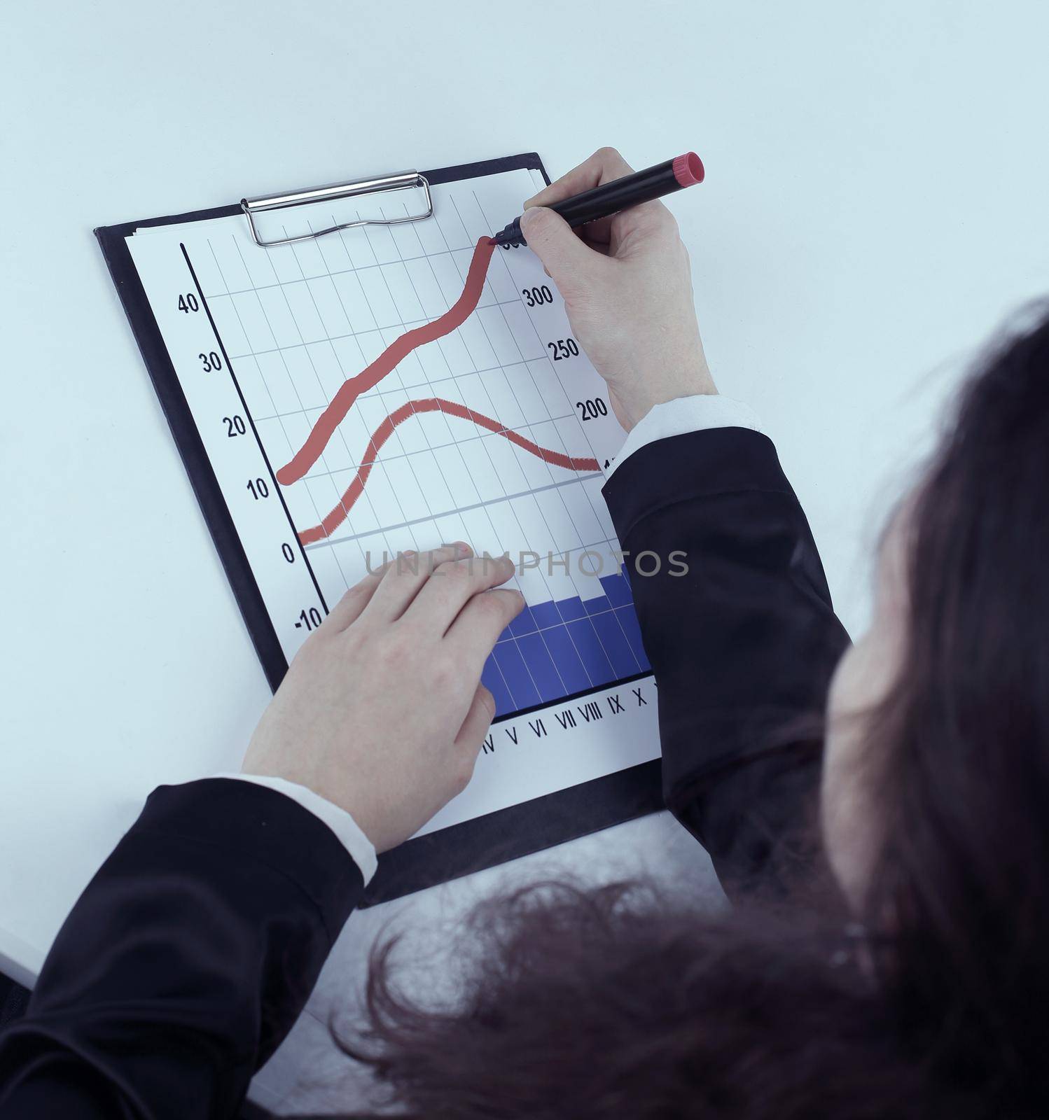 close-up. business woman making a marketing schedule.isolated on white background