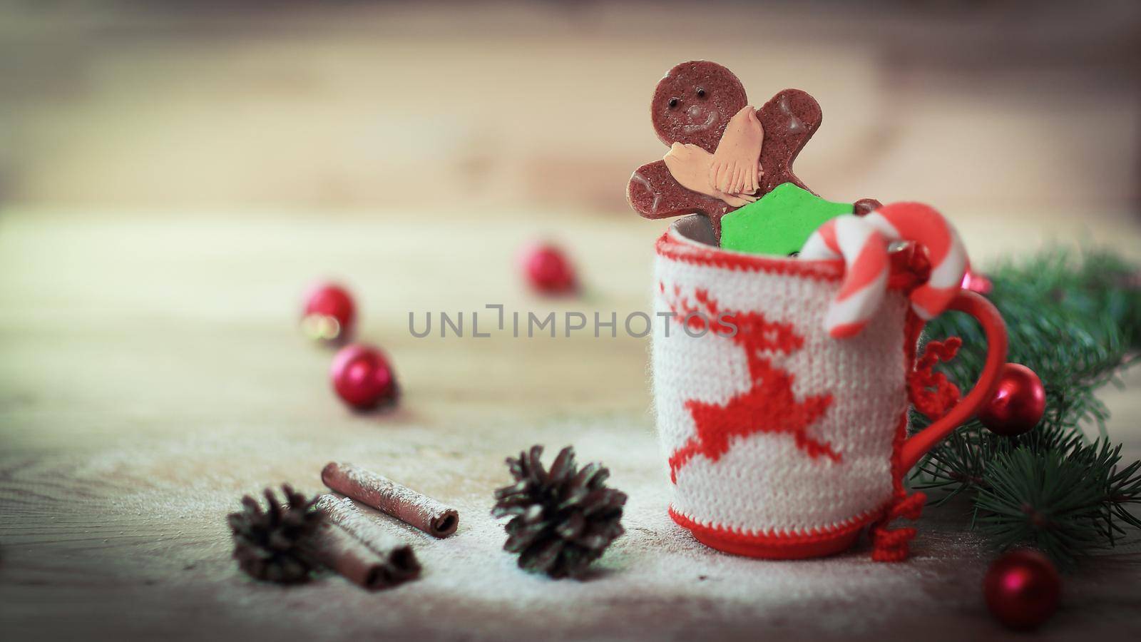 Christmas Cup ornament and a fun gingerbread on a wooden table .photo with copy space .