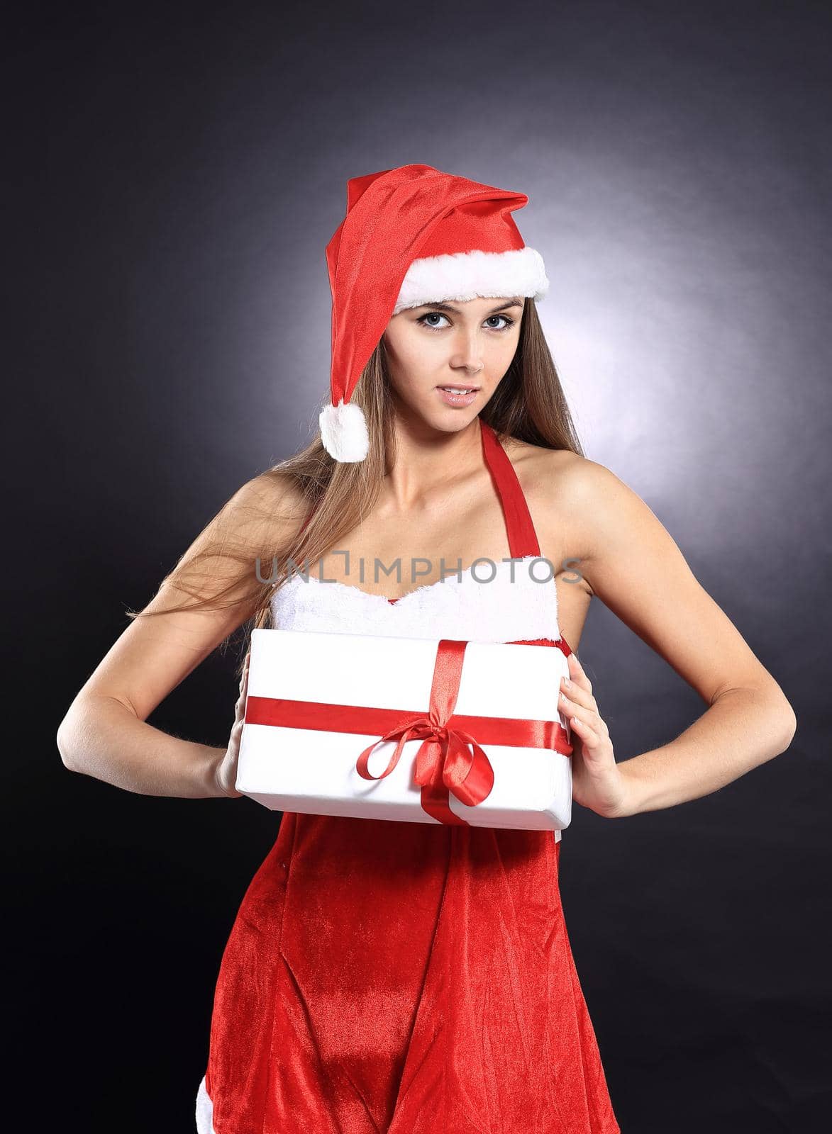 beautiful woman in costume of Santa Claus with Christmas shopping. isolated on a black background.photo with copy space.