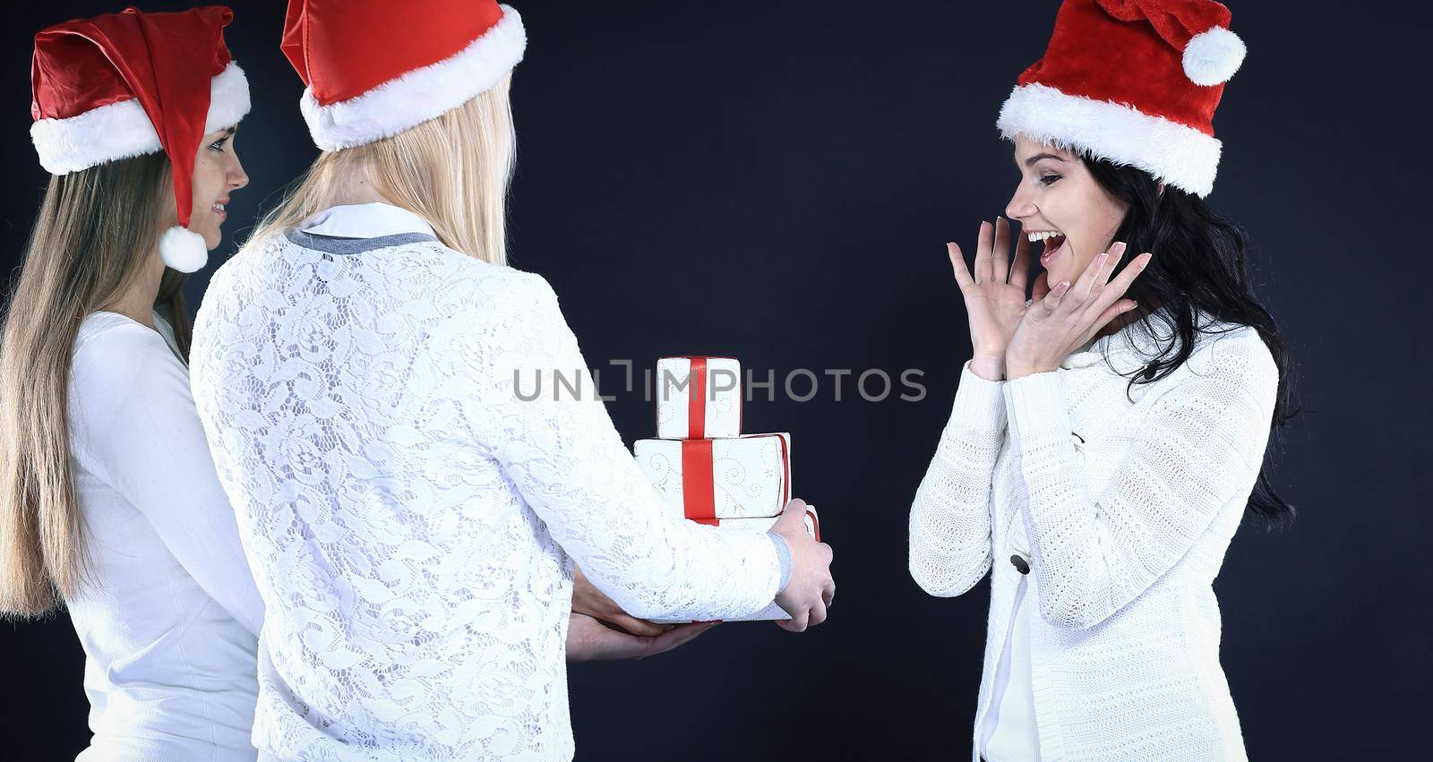 three happy young girl in costume of Santa Claus with Christmas by SmartPhotoLab