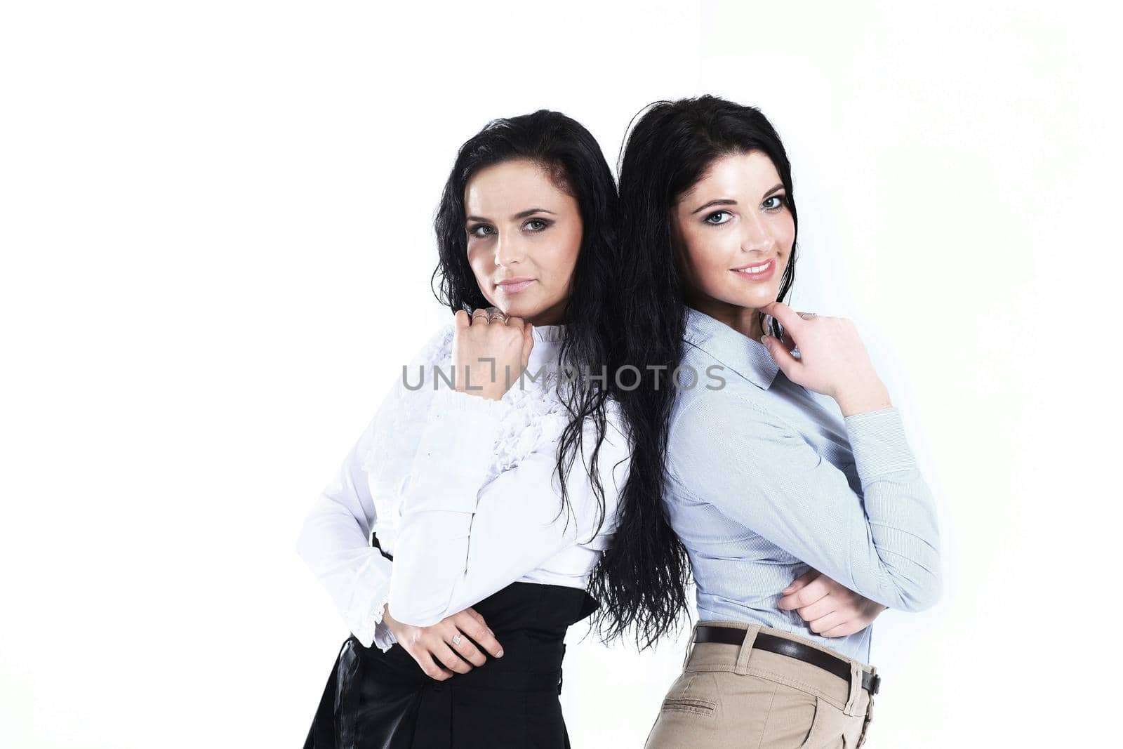 portrait of two young female employees on white background by SmartPhotoLab