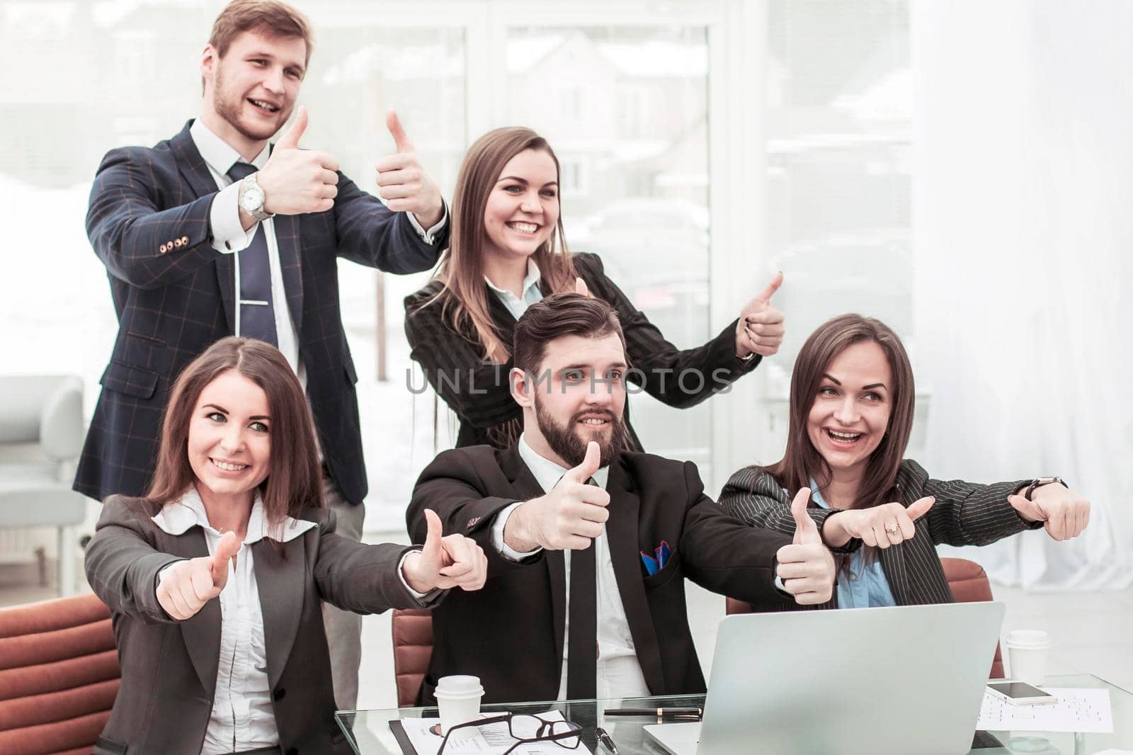 professional business team near the desktop, together make the gesture thumbs up