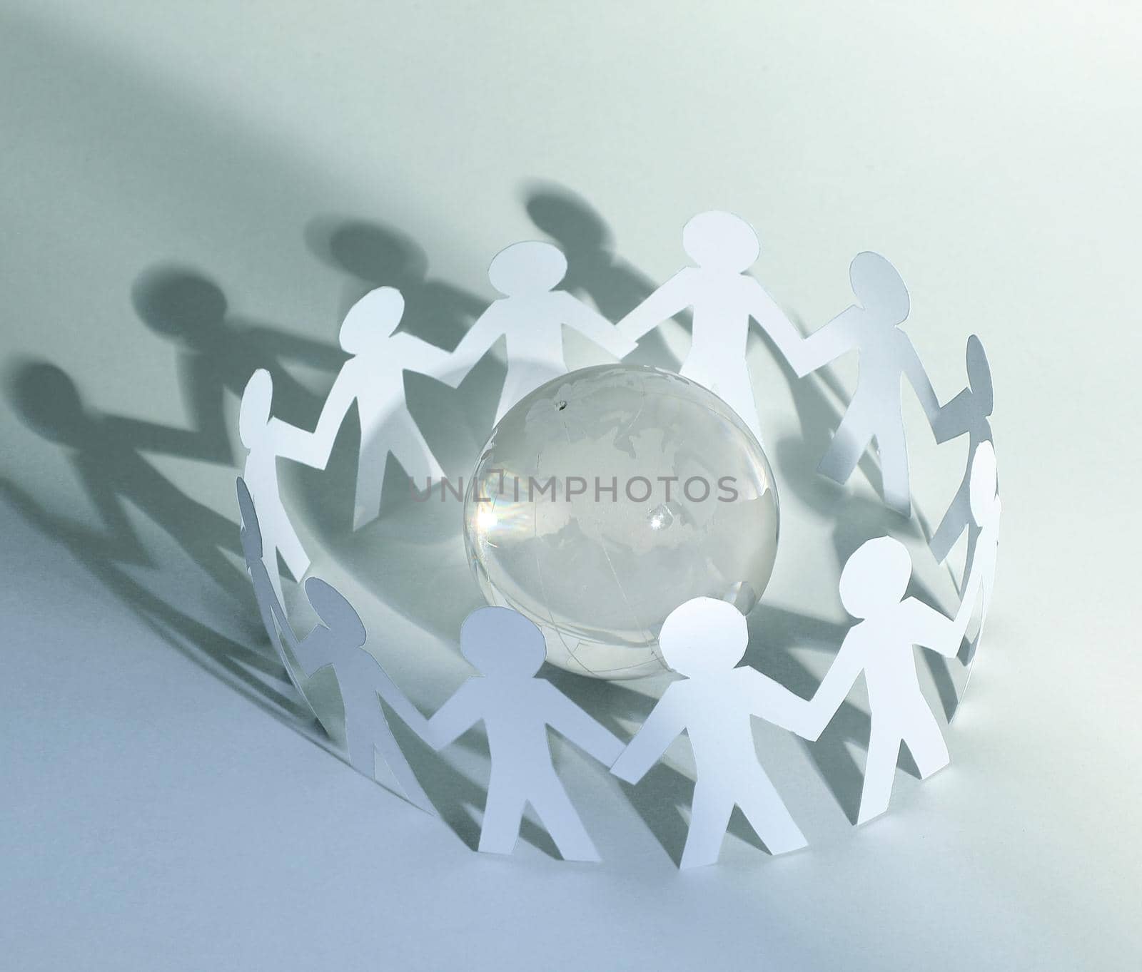 business background.team paper men standing around the glass globe.photo with copy space