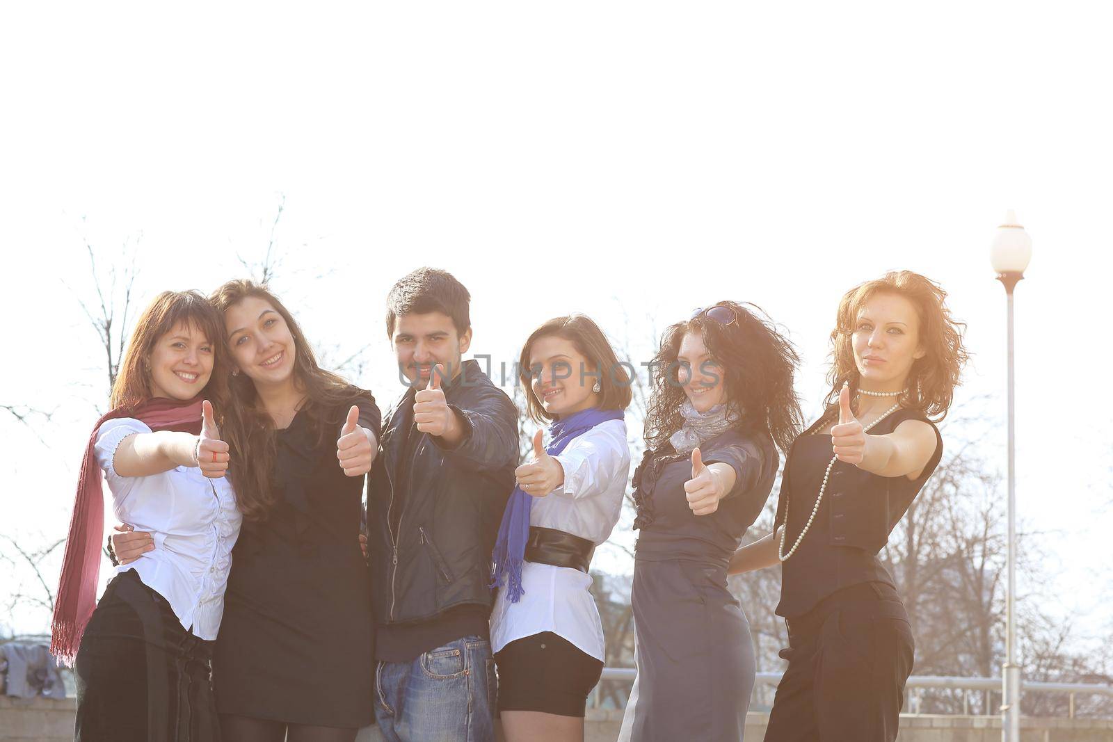 closeup. a group of successful students showing thumb up