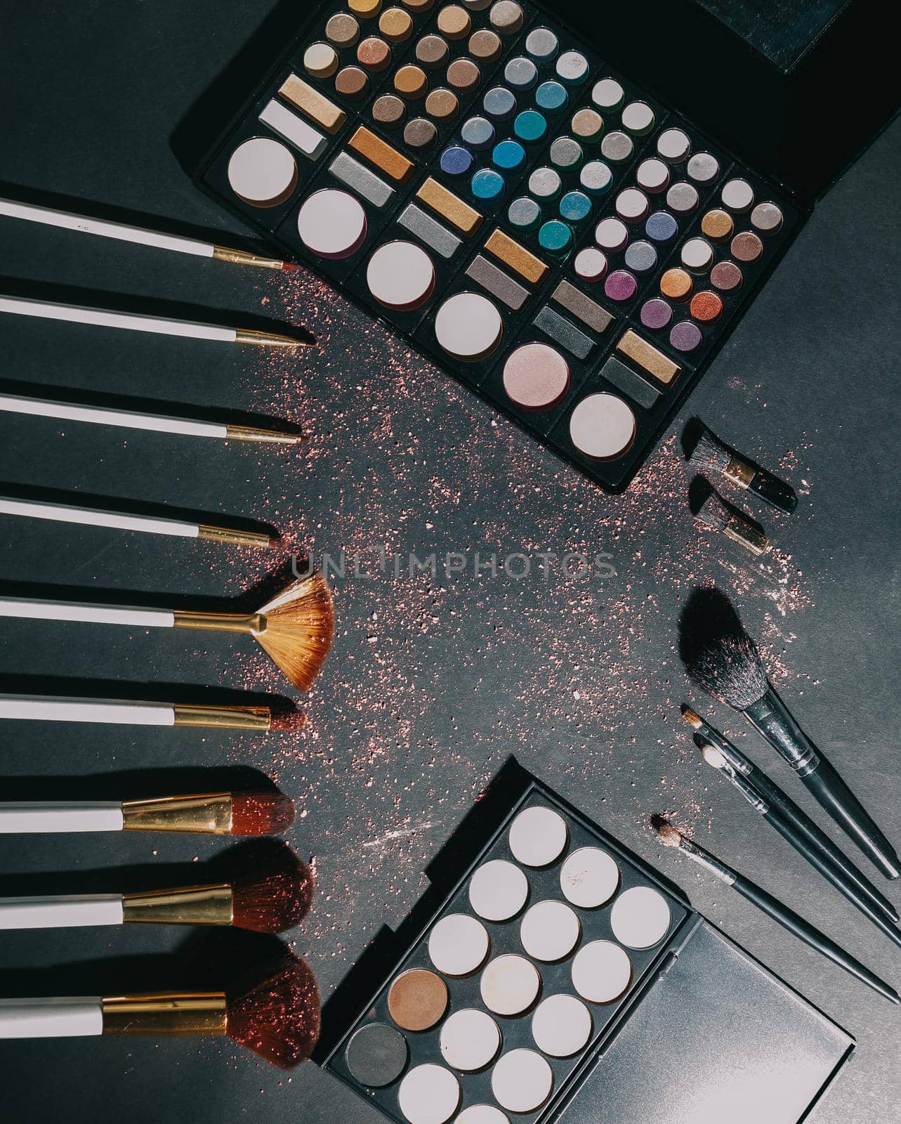 makeup brushes and eye shadow on black background.photo with copy space