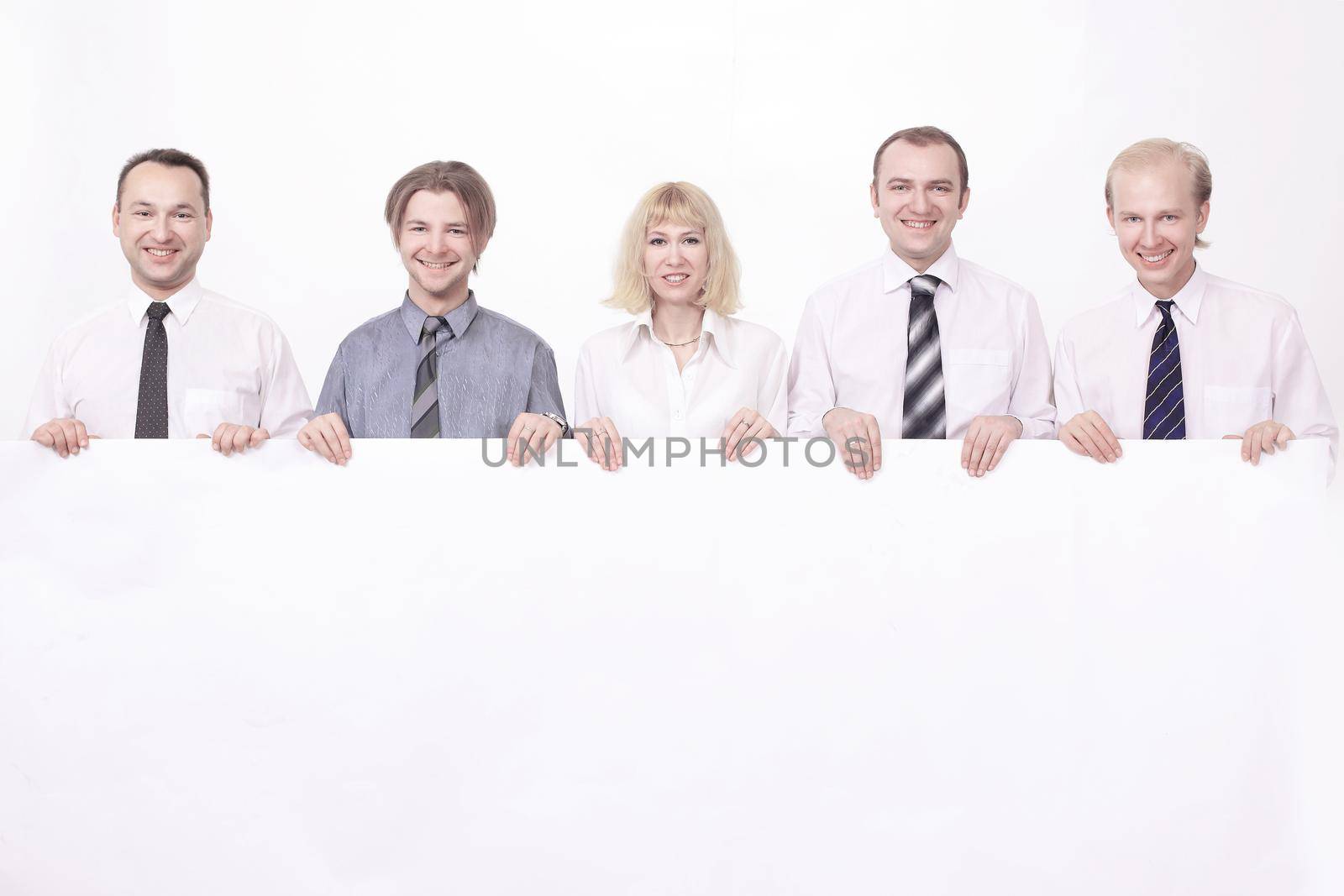 members of the business team holding a large blank banner. by SmartPhotoLab
