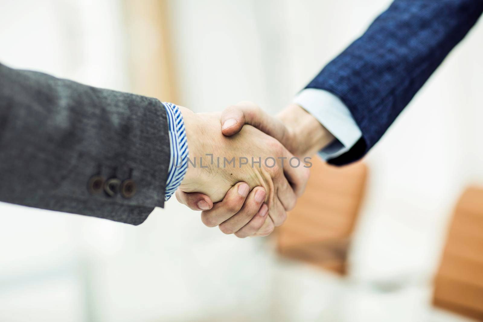 handshake of business partners on blurred light background.the photo has a empty space for your text