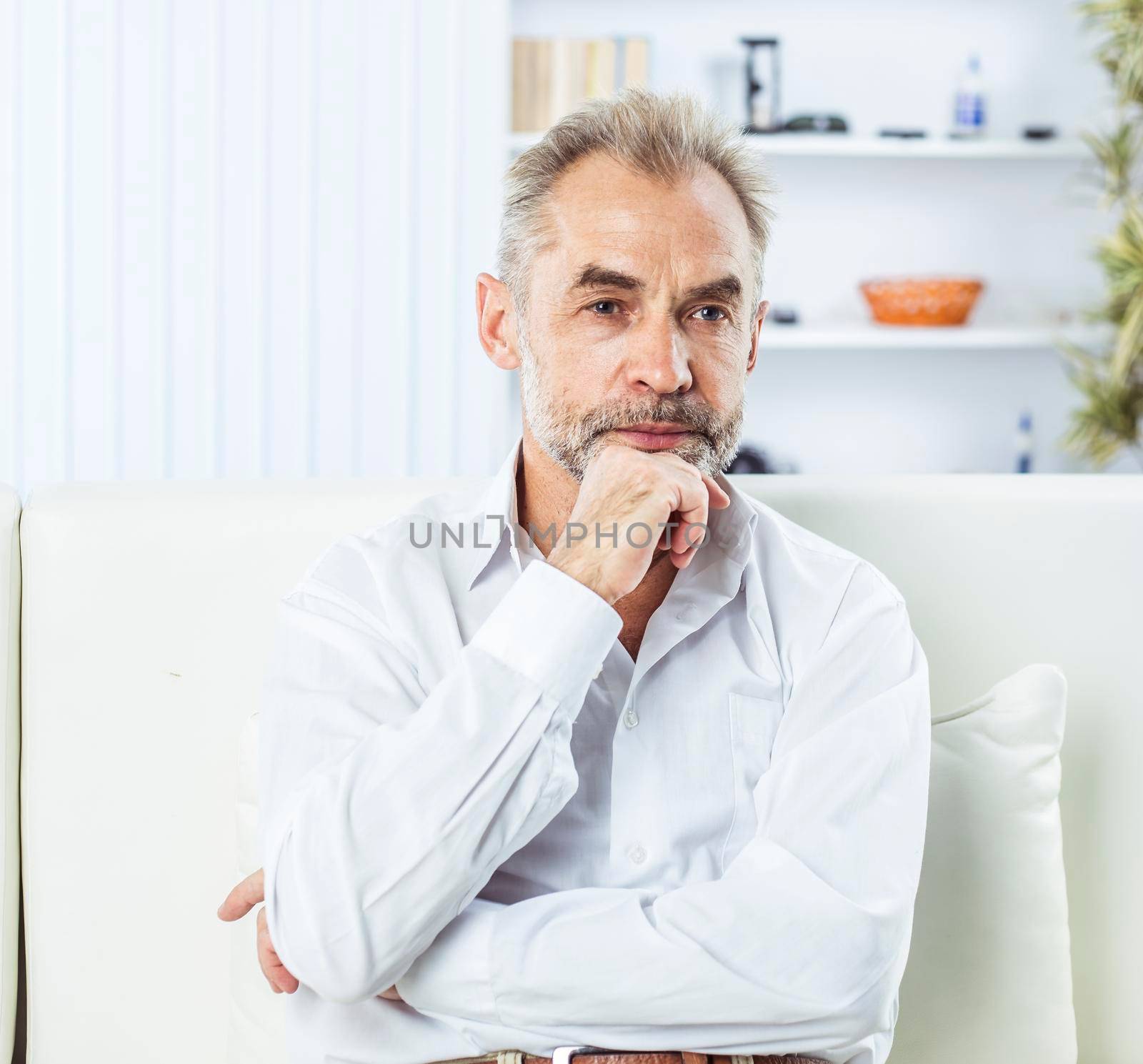 businessman on background of office. the photo has a empty space for your text