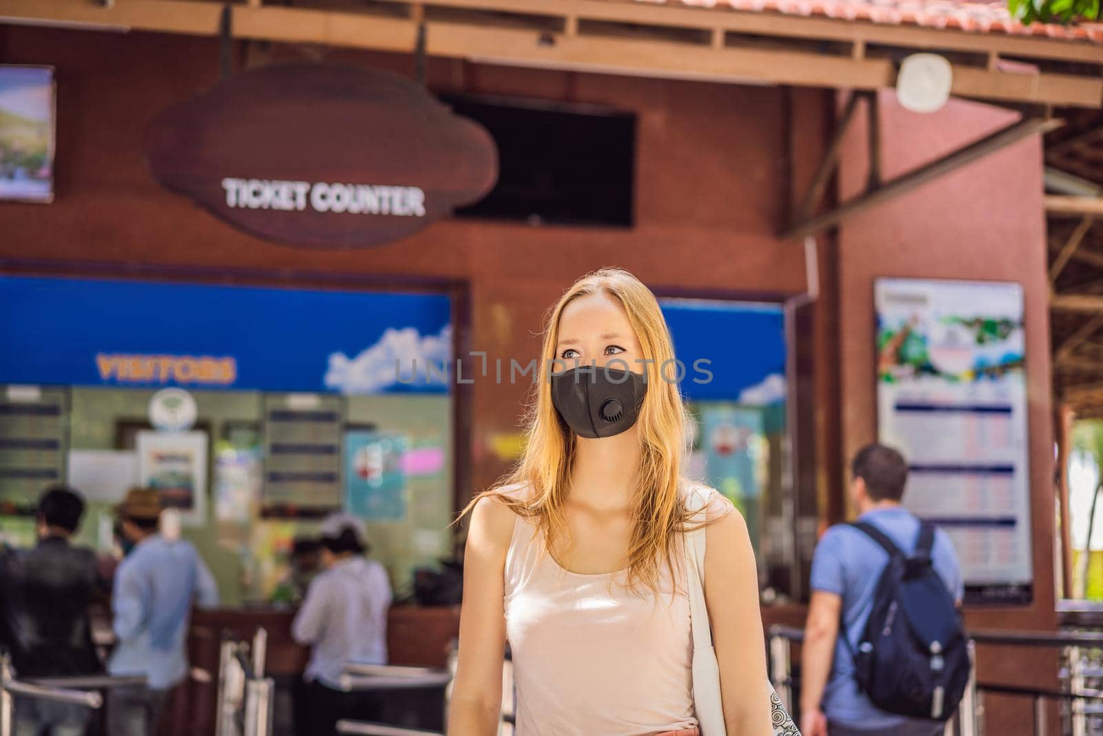 young woman wearing a hygiene protective mask over her face while walking at the crowded place. Healthcare and sickness prevention from coronavirus, Covid19 influenza in crowded place.