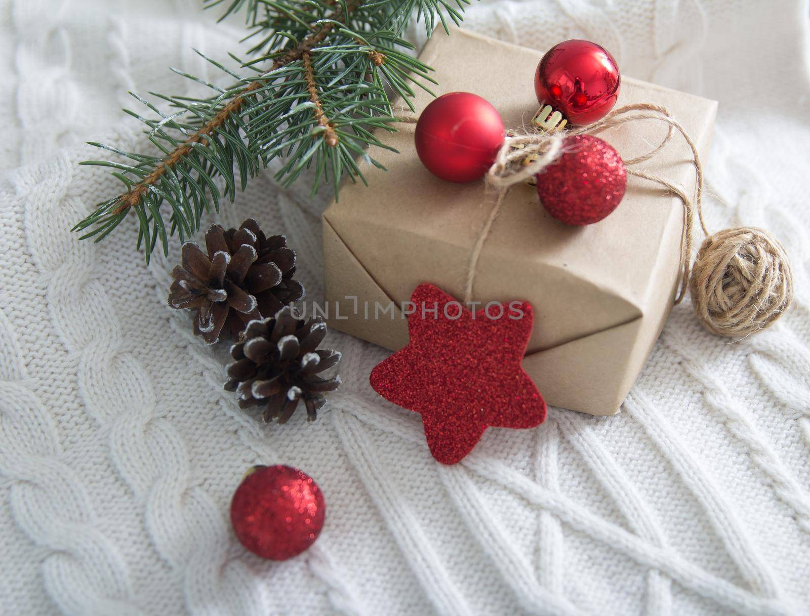 gift box and Christmas tree branch and decorations on white background