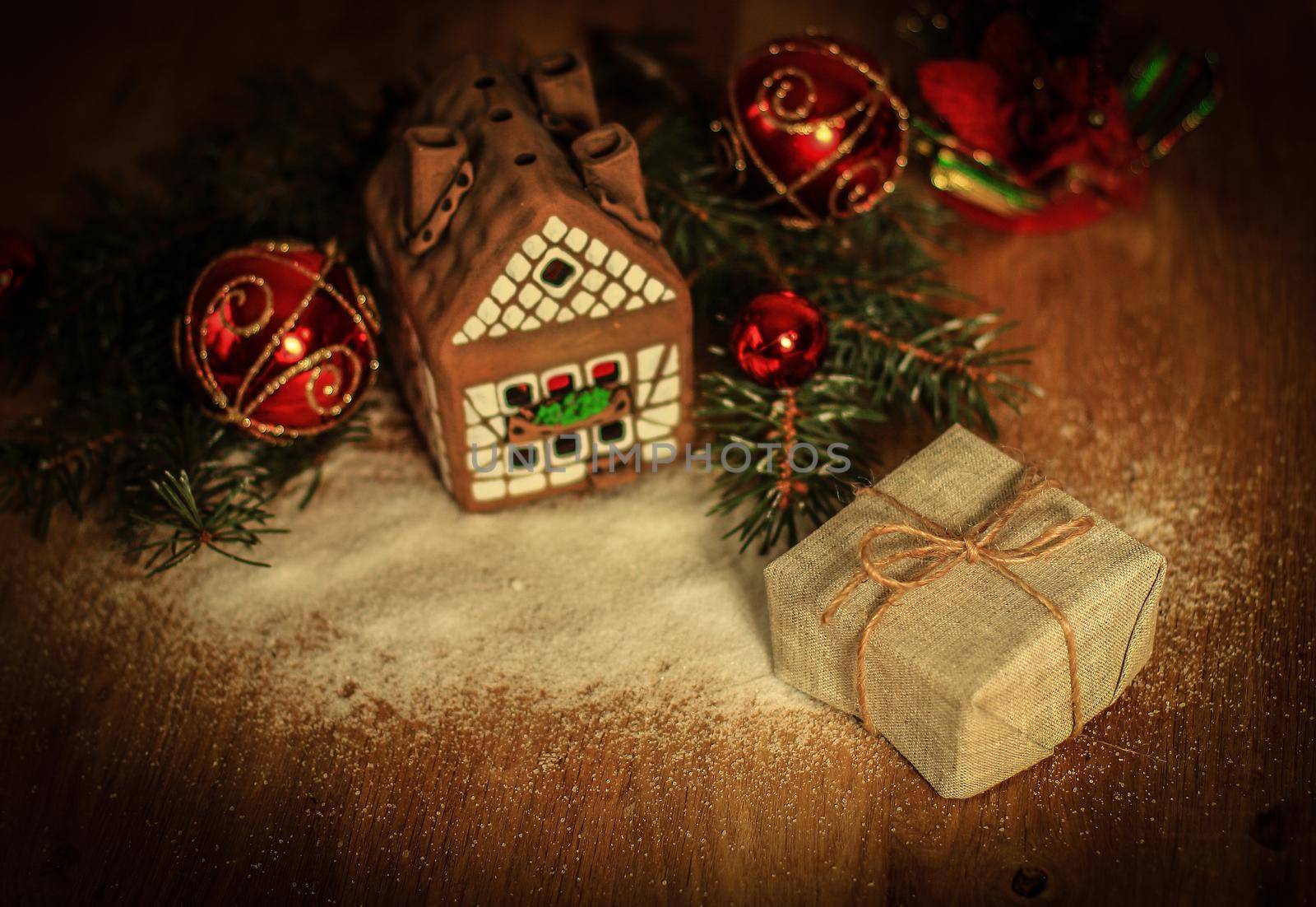Christmas present on the background of a gingerbread house.photo with copy space