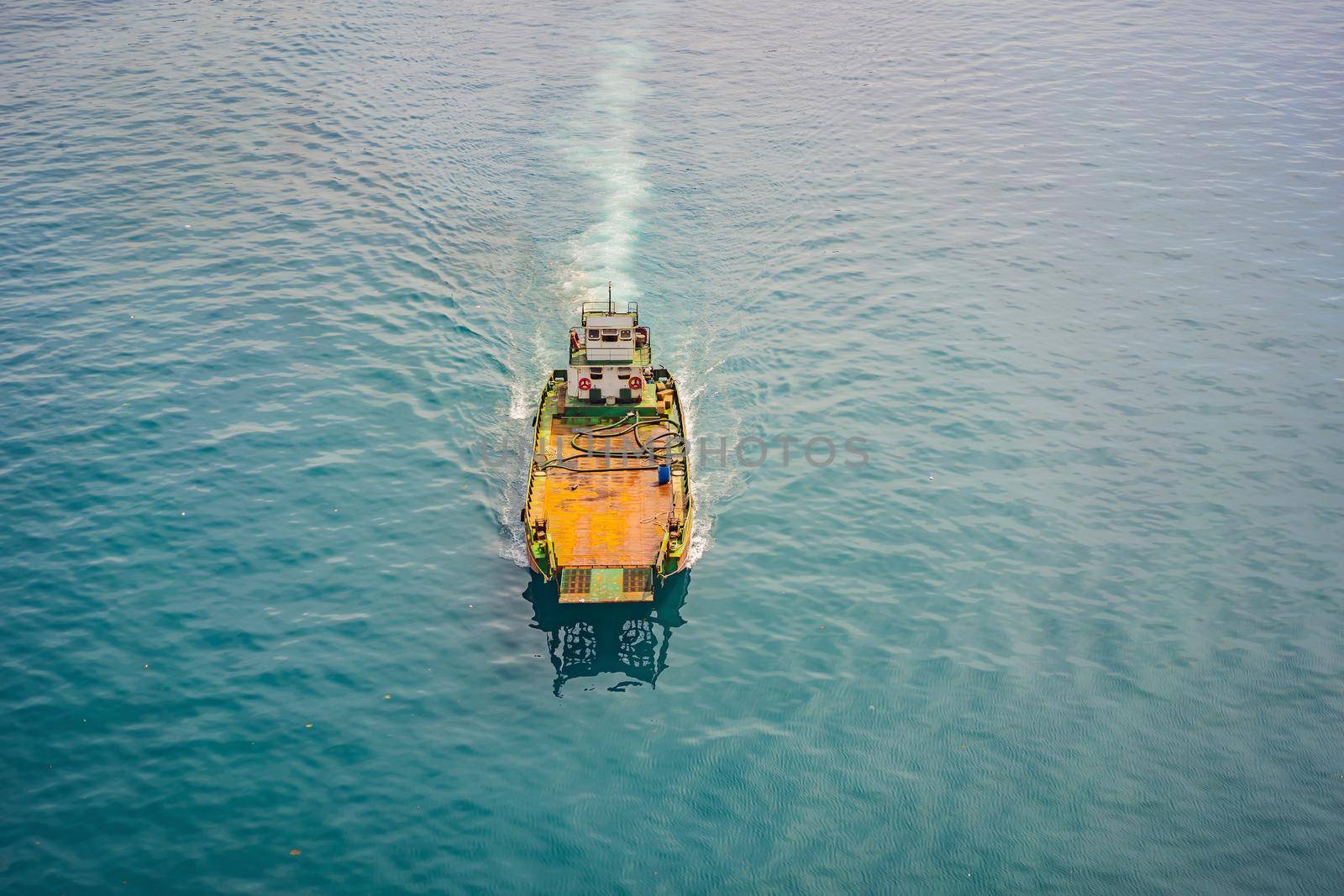 Aerial drone photo of small ferry cruising open ocean sea.