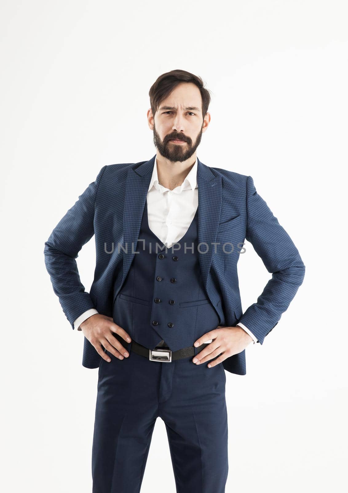 successful businessman in a business suit and standing with his hands on the belt.the photo has a empty space for your text