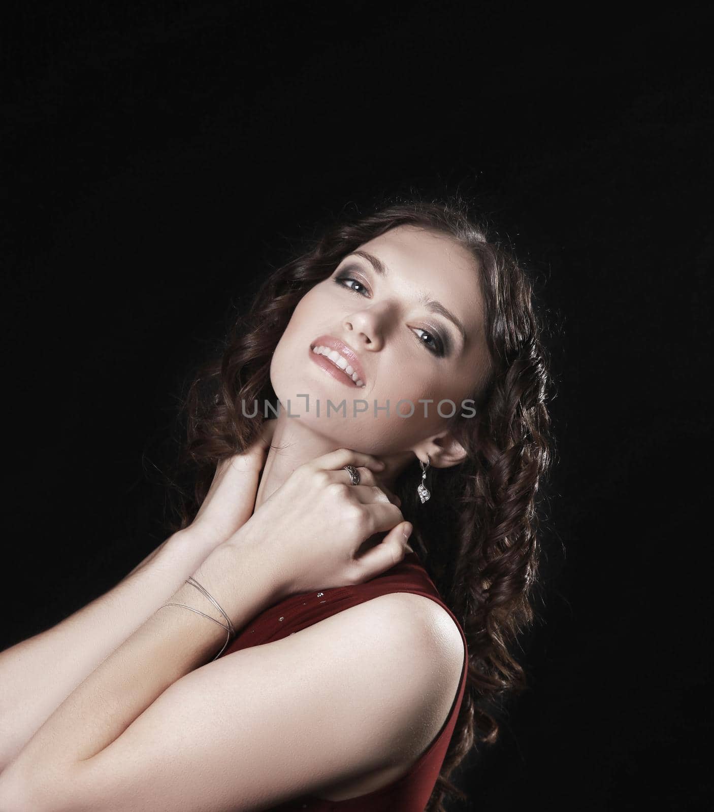 closeup. portrait of beautiful woman in red dress posing for the camera.isolated on black background