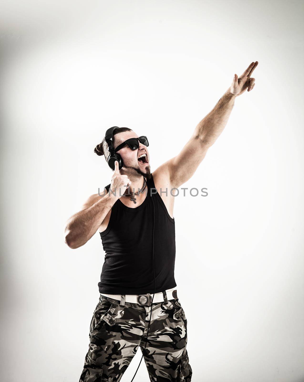 DJ - rapper in headphones takes the rap and break dancing dance on a light background.the photo has a empty space for your text