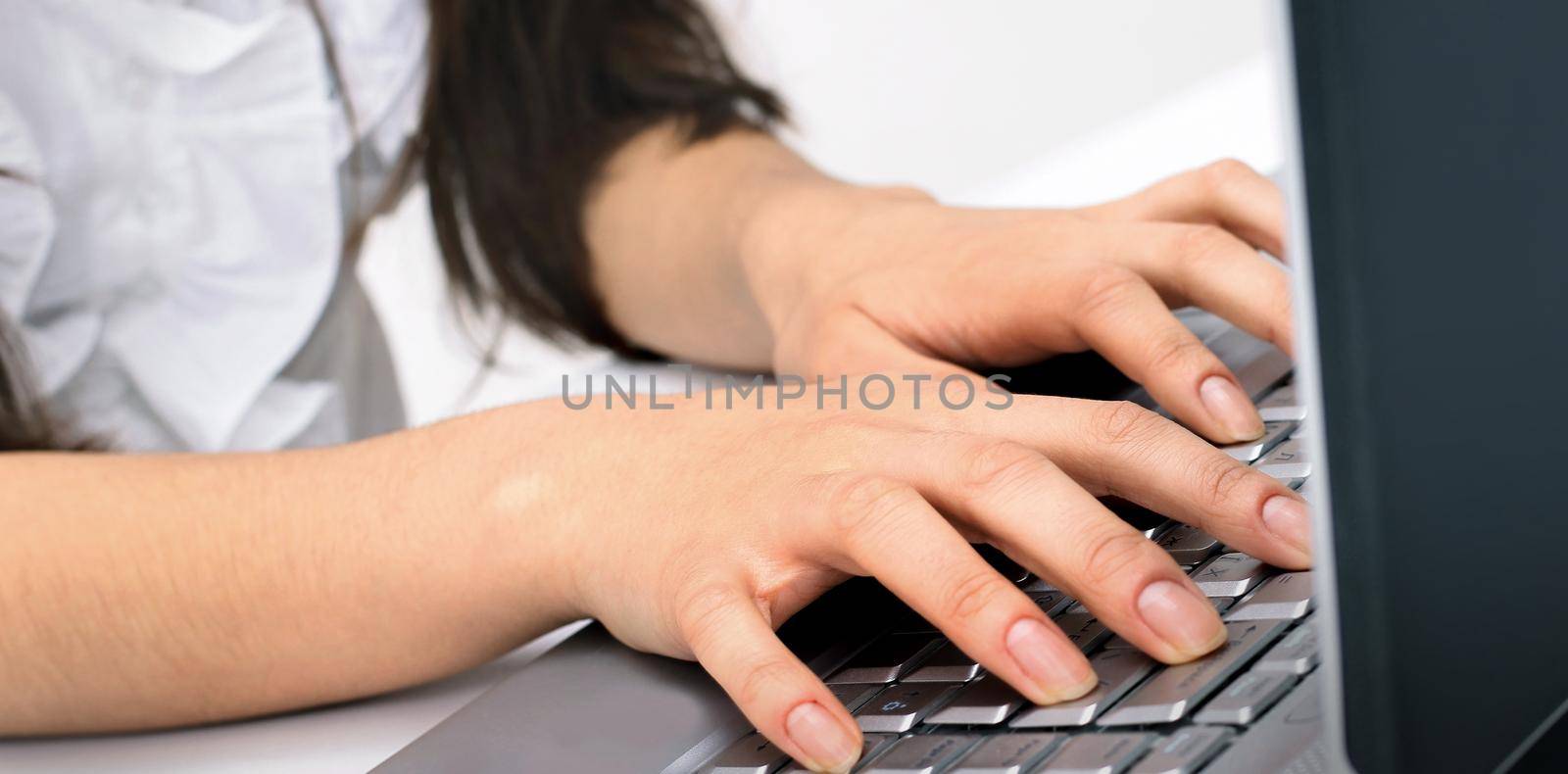 closeup.young business woman typing on the laptop keyboard.people and technology.