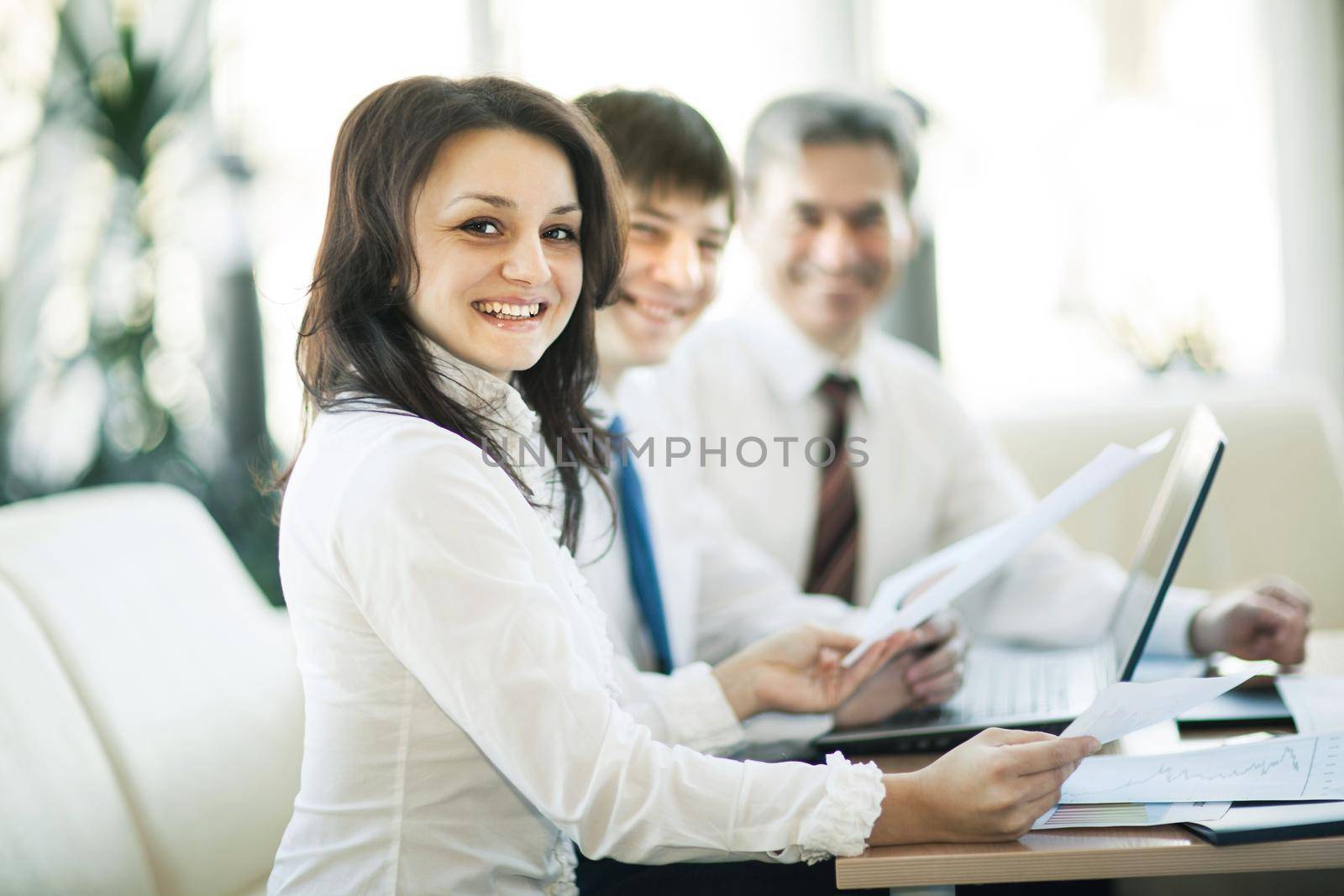 A group of businessmen discussing the policy of the company in the office. by SmartPhotoLab