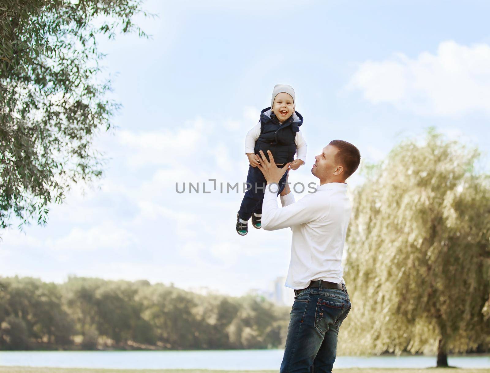 Happy father and son on a walk on a Sunny day by SmartPhotoLab