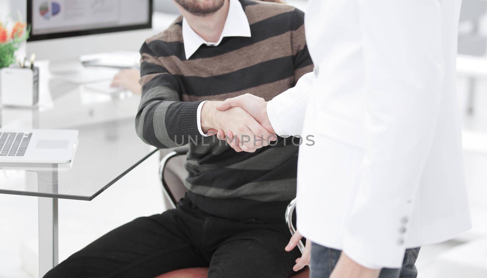 handshake Manager and client in the office. by SmartPhotoLab