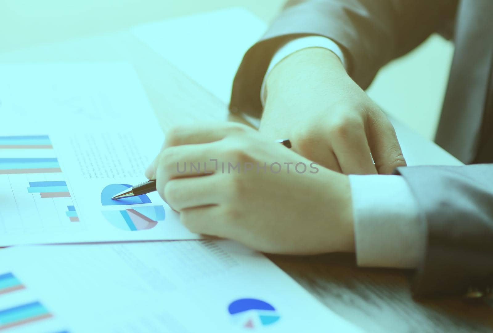 Image of human hands with pens pointing at business document in the meeting by SmartPhotoLab