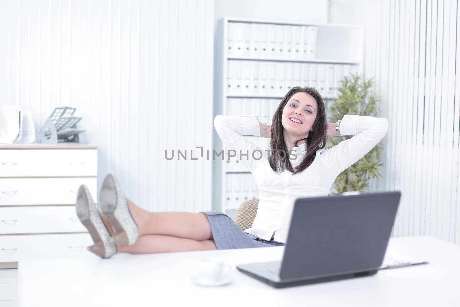 smiling employee in a work break ,sitting at the table. photo with copy space