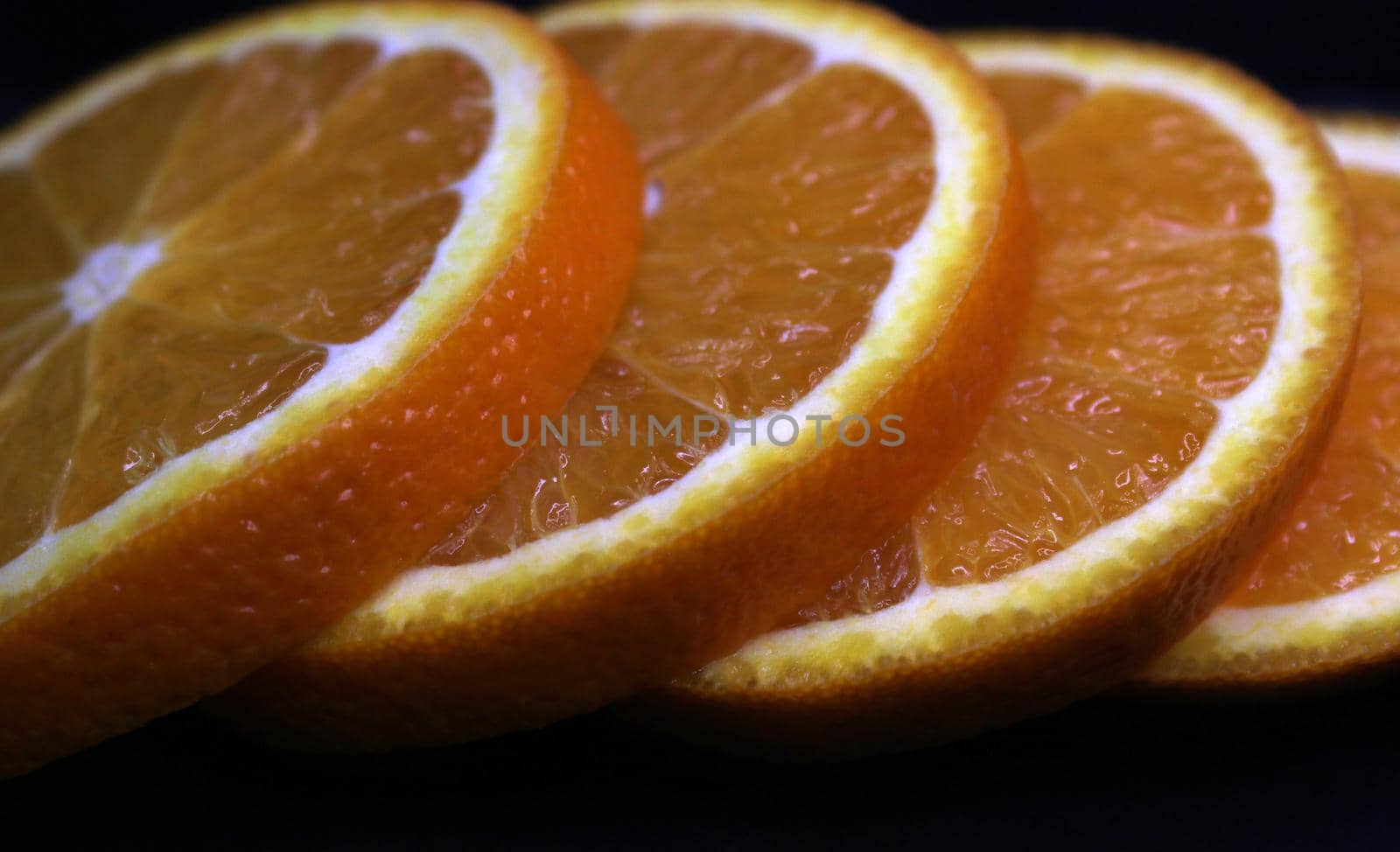Close-up of orange slices on a black background..