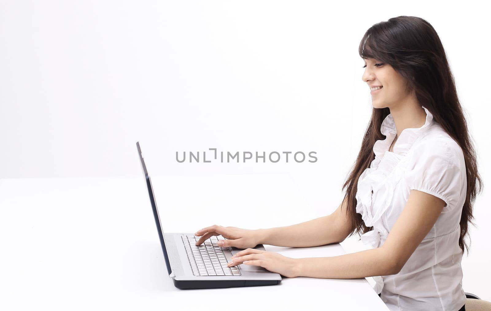 young woman typing text on laptop keyboard by SmartPhotoLab