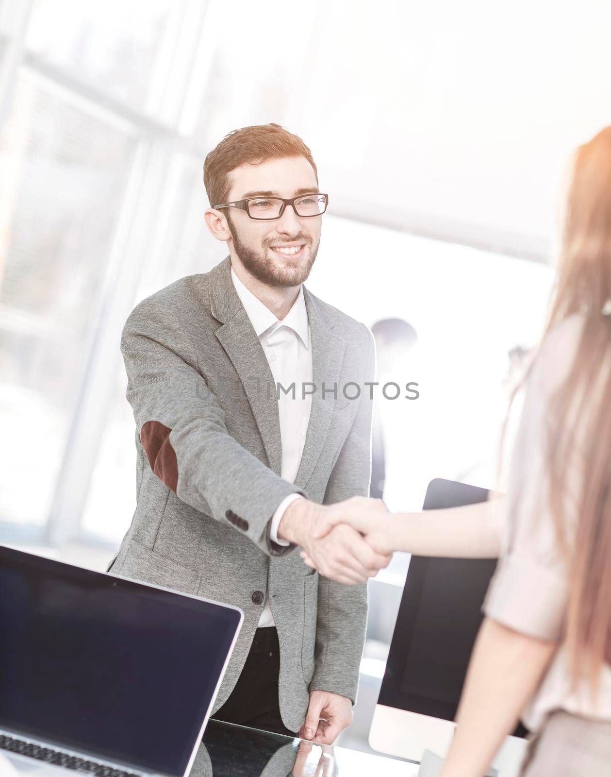 closeup - the lawyer and the client, shake hands after signing the financing contract.the photo has a empty space for your text.