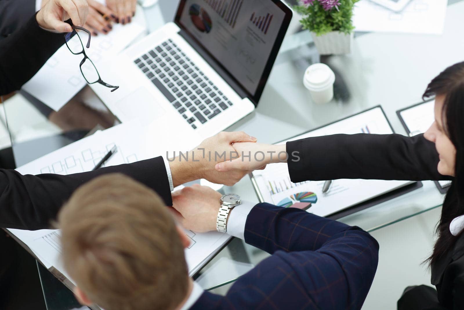 close up.handshake business partners over the Desk by SmartPhotoLab