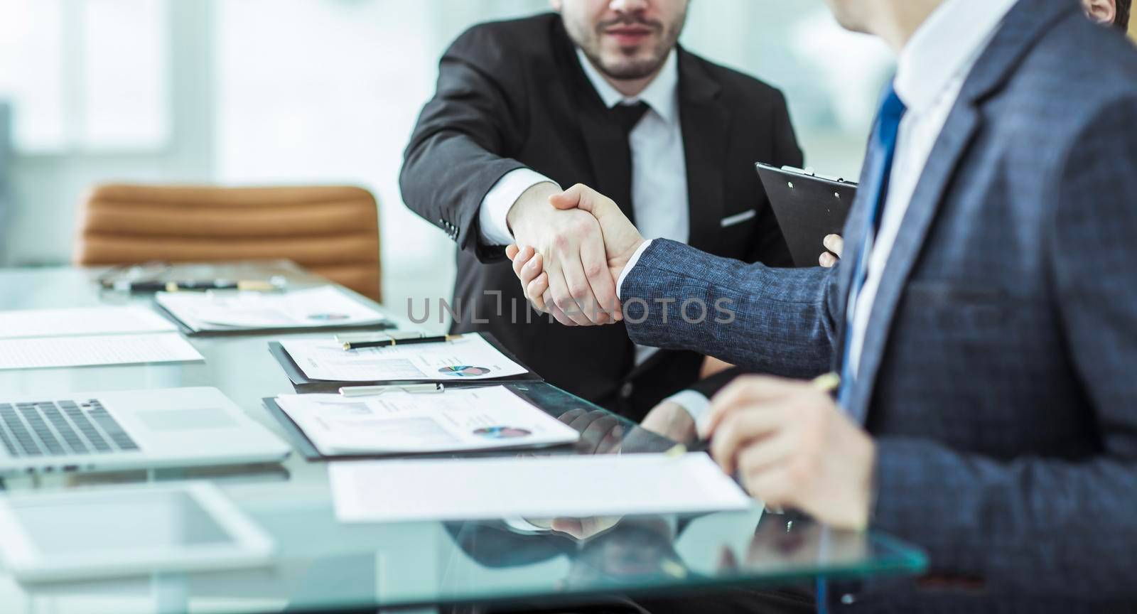 handshake of two lawyers after discussing the terms of a financial contract by SmartPhotoLab