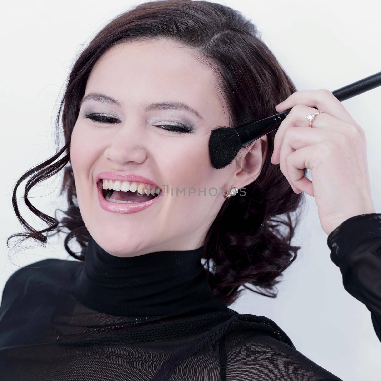 stylish young woman with brush for makeup. by SmartPhotoLab