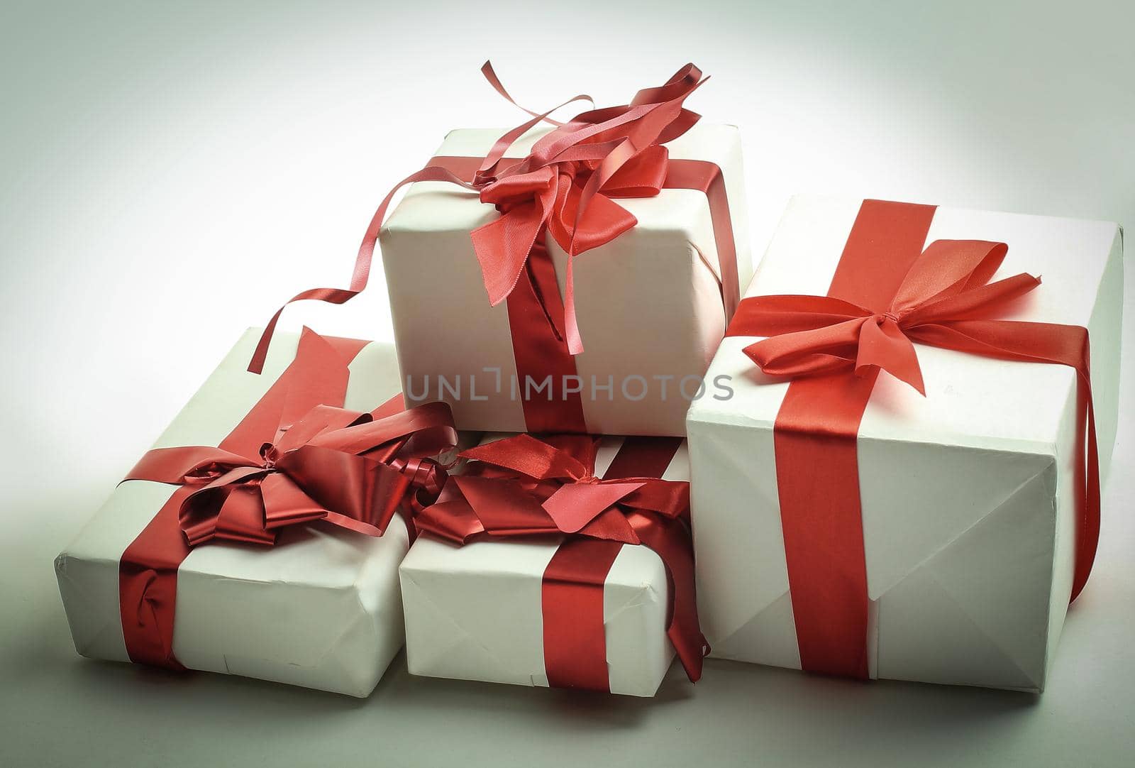 Elegant gift boxes with red satin ribbon wrapped in paper.isolated on a white background