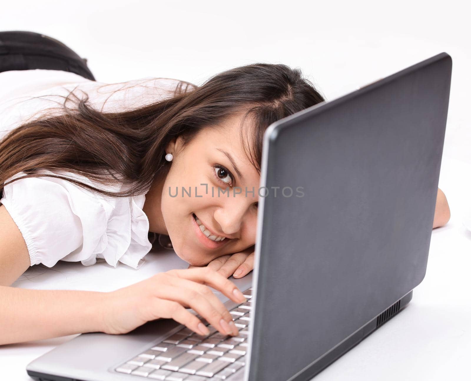 closeup. smiling young woman with laptop in the workplace.isolated on white.