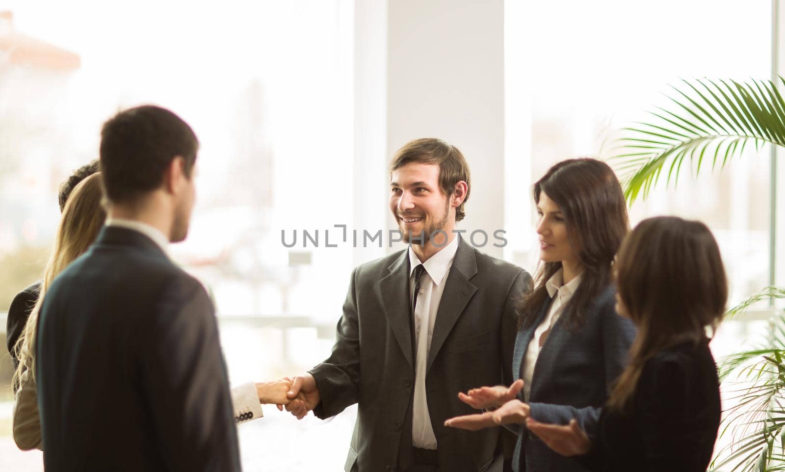 Handshake of businessmen. Conclusion a very important contract in the office standing