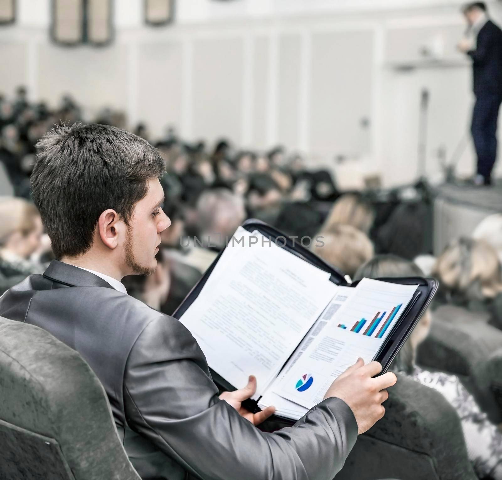 in the foreground: a businessman on a business conference. business training
