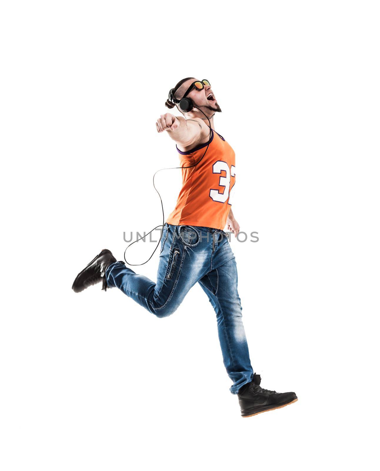 charming guy - rapper in headphones takes the dance break.photo on a white background and has an empty space for your text