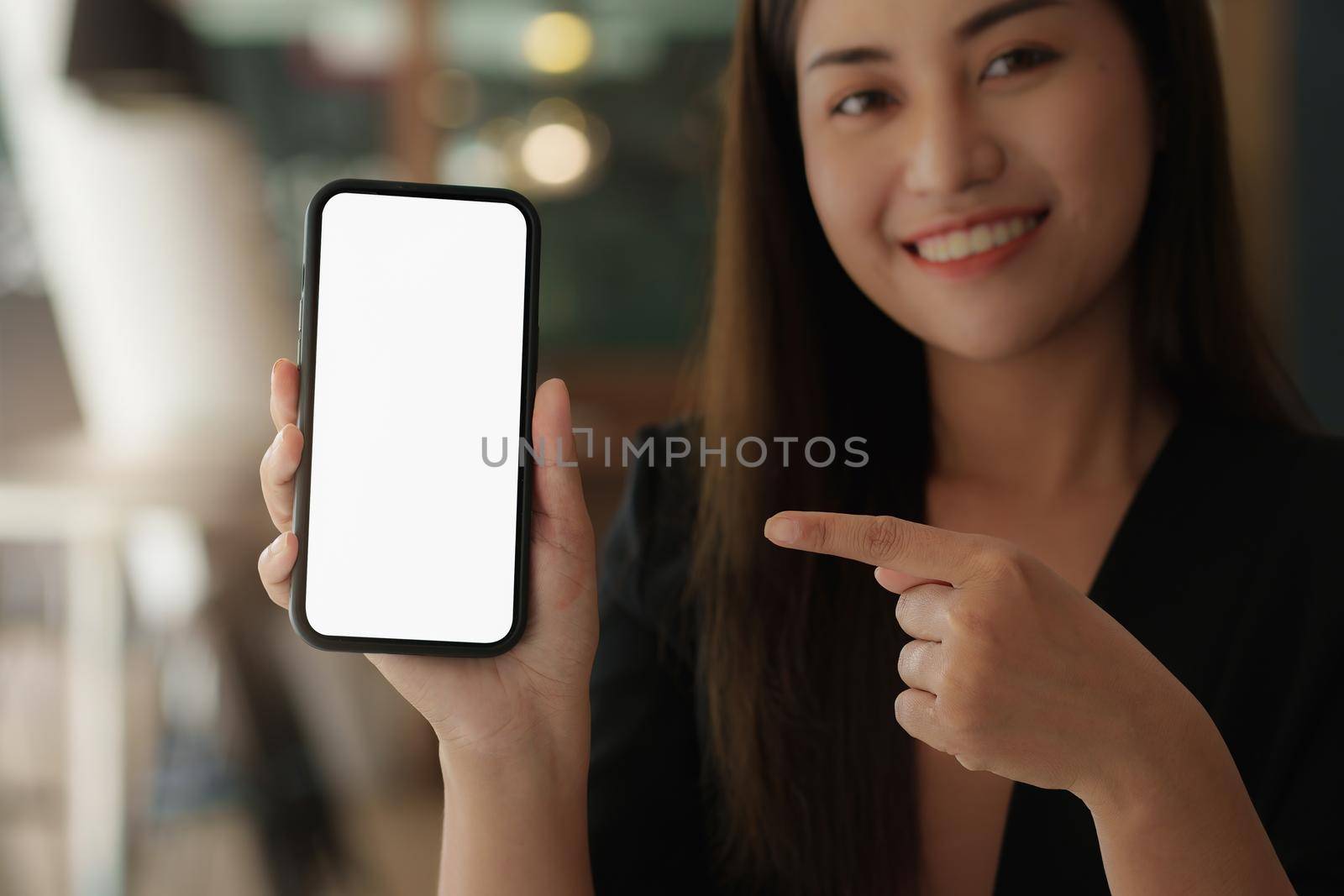 A Woman excited surprise and showing cell phone screen. Blank screen for your advertising