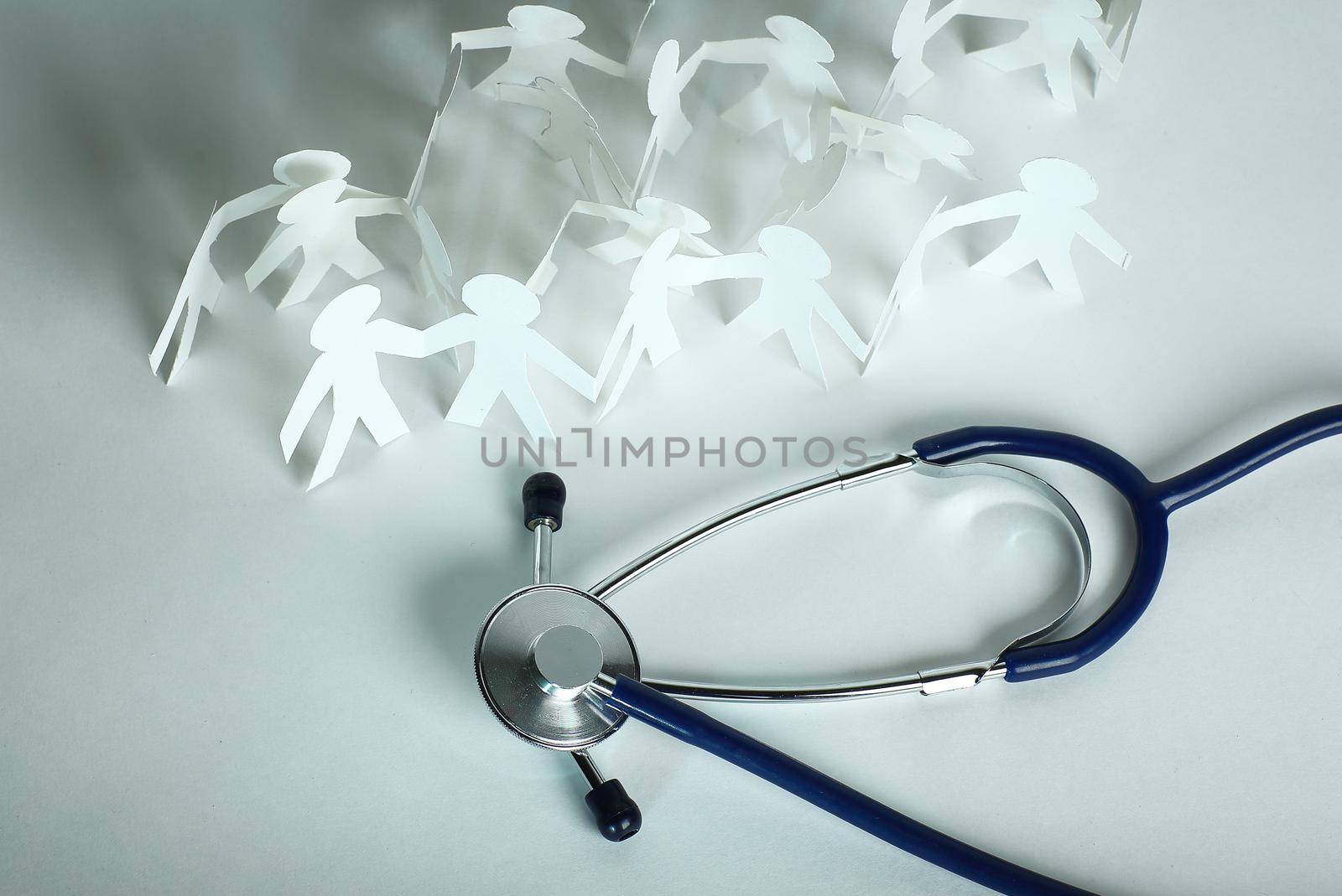 stethoscope and paper men on the table. by SmartPhotoLab