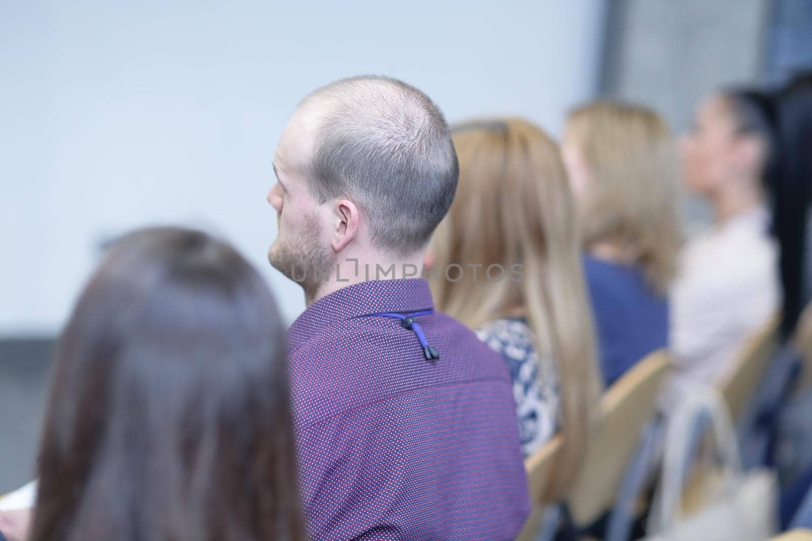 rear view.businessmen sitting in a conference room by SmartPhotoLab