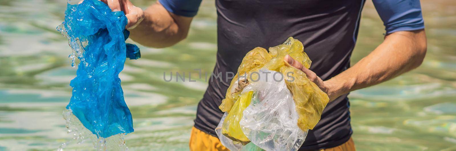 Man collects packages from the beautiful turquoise sea. Paradise beach pollution. Problem of spilled rubbish trash garbage on the beach sand caused by man-made pollution and environmental, campaign to clean volunteer in concept. BANNER, LONG FORMAT