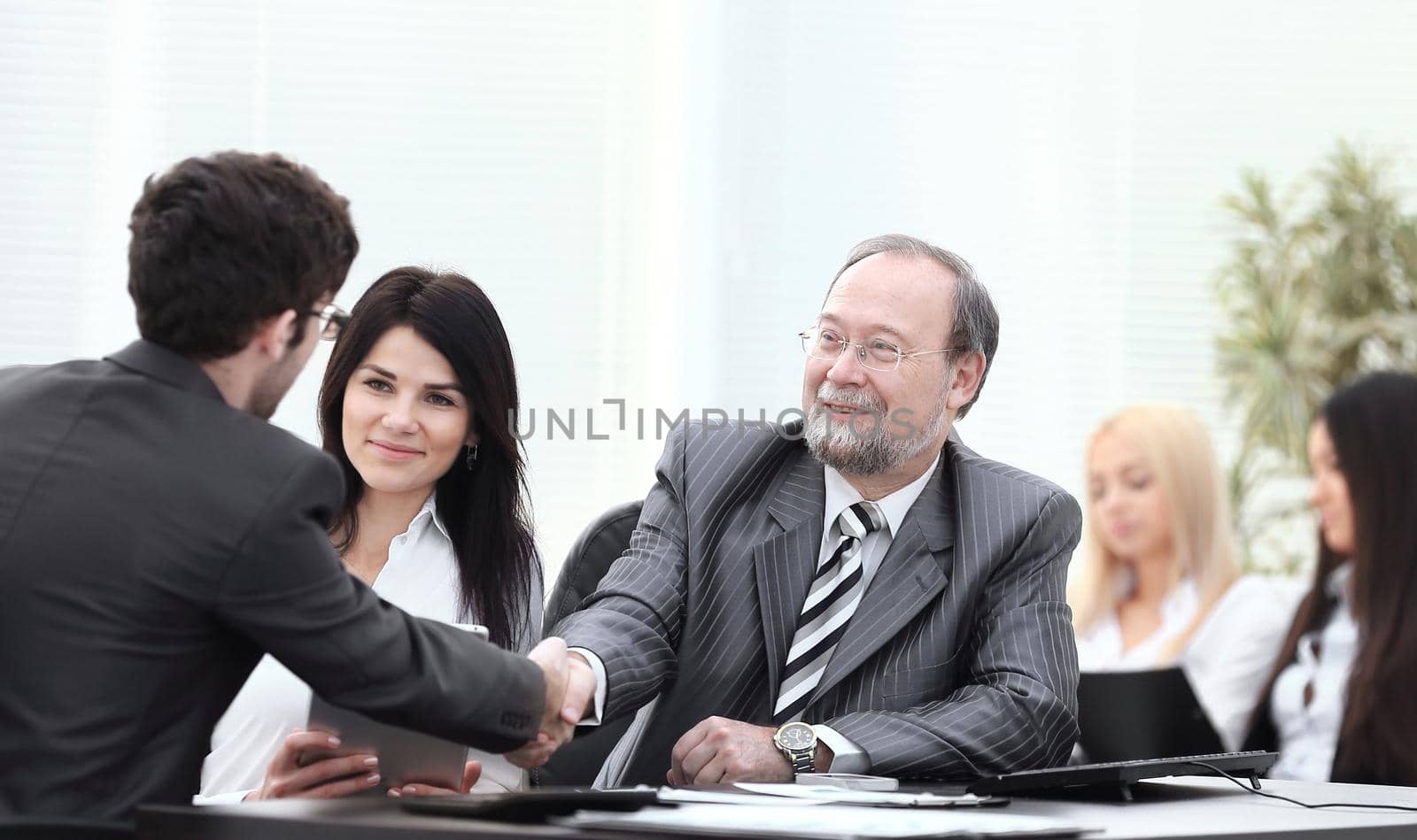 handshake between colleagues in the workplace in the office.photo with copy space