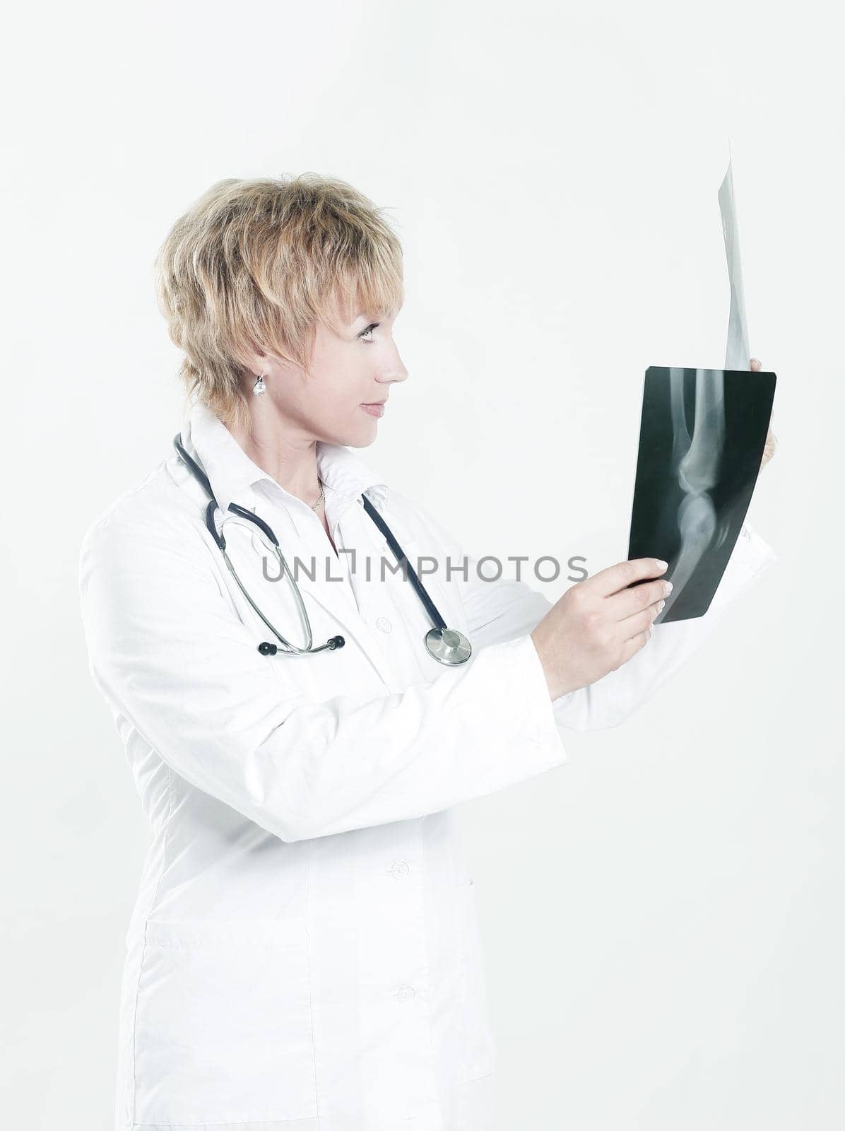 female doctor checking x-ray of the patient . by SmartPhotoLab