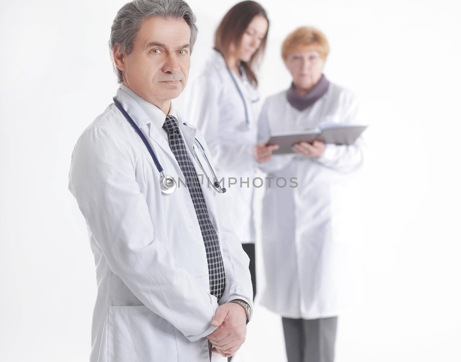 serious therapist doctor on blurred background of colleagues by SmartPhotoLab